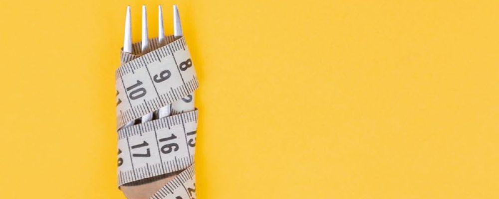 Stylized image of a fork wrapped in a measuring tape on a yellow background.